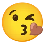 face blowing a kiss + brown heart