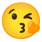 face blowing a kiss + orange heart