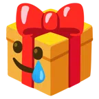 Geschenk + lachendes Gesicht mit Träne